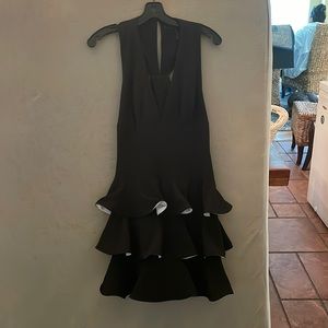 Short black BCBG cocktail dress, with white accents. Size 8.